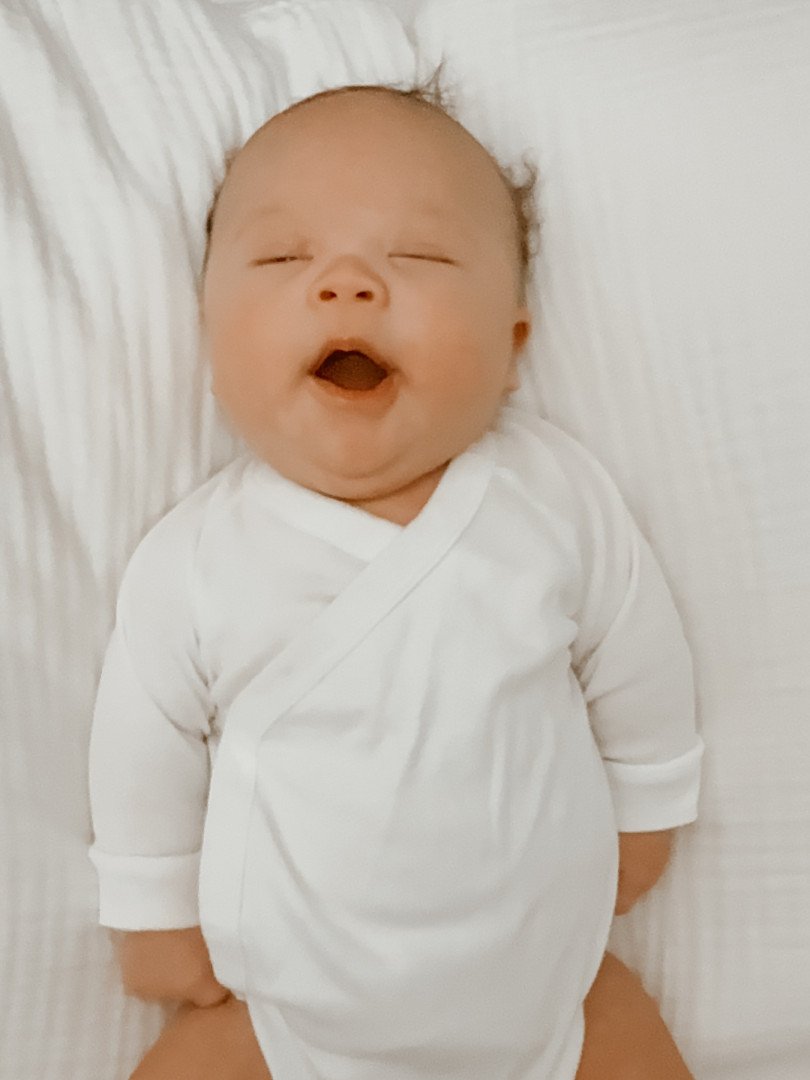 Olli wearing a handmade Jesus loves Oliver bib